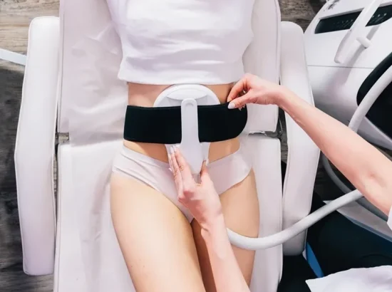 A patient undergoing an EMS (Electrical Muscle Stimulation) treatment at a med spa. EMS Paddle is placed on the skin, sending mild electrical impulses to stimulate muscle contractions for toning and strengthening.
